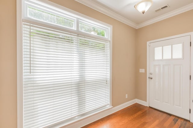 entrance foyer with light hardwood / wood-style floors and ornamental molding