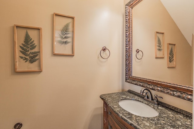 bathroom with vanity and lofted ceiling