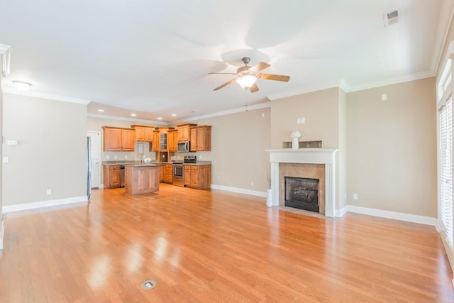 unfurnished living room featuring ceiling fan, light hardwood / wood-style floors, and crown molding