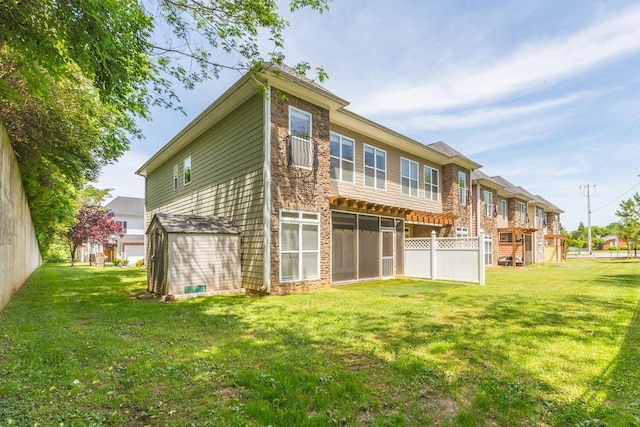 rear view of property with a yard