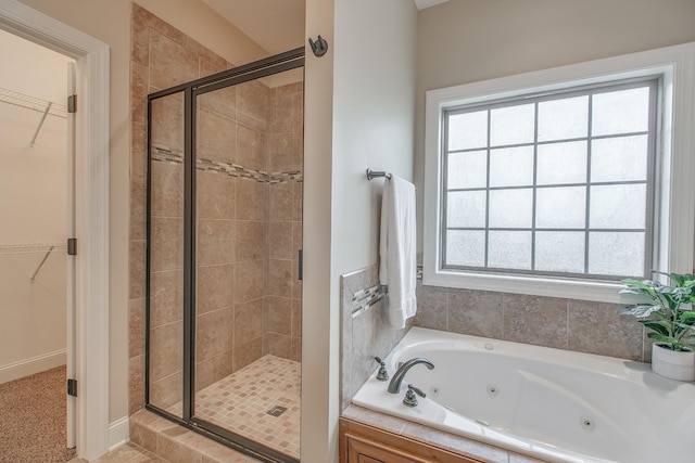 bathroom featuring separate shower and tub