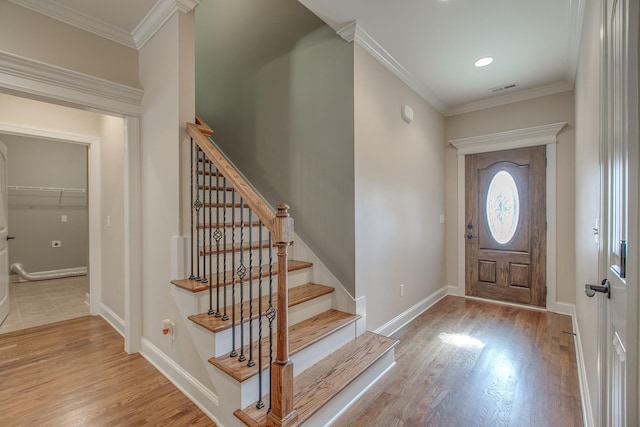 entrance foyer featuring light hardwood / wood-style floors and ornamental molding