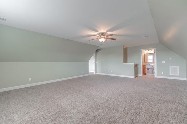 additional living space featuring carpet flooring, ceiling fan, and lofted ceiling