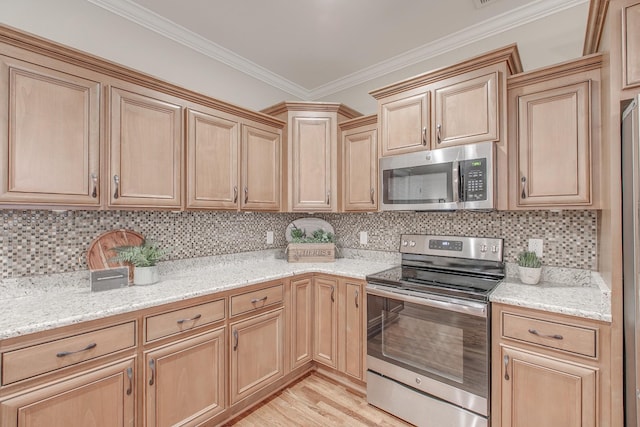 kitchen with crown molding, light stone counters, stainless steel appliances, and tasteful backsplash