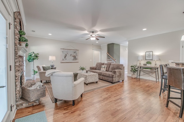 living room with hardwood / wood-style floors, ceiling fan, and crown molding