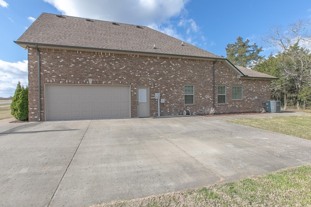 view of home's exterior featuring cooling unit and a garage