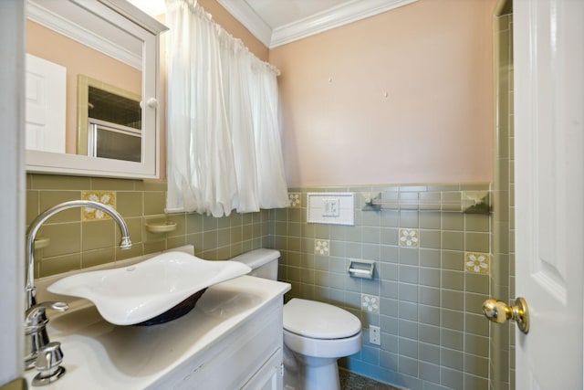 bathroom featuring vanity, toilet, tile walls, and crown molding