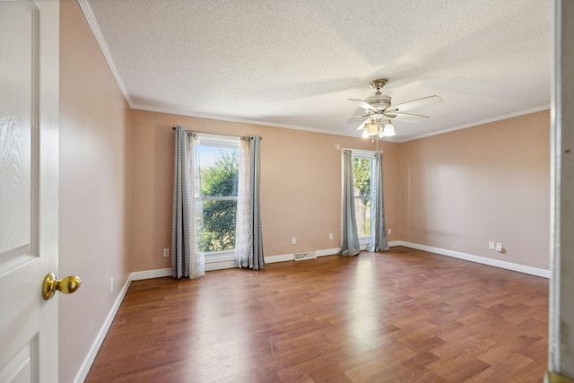 spare room with wood-type flooring, a textured ceiling, ceiling fan, and ornamental molding