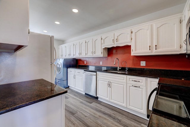 kitchen with stainless steel dishwasher, white cabinets, sink, and light hardwood / wood-style flooring