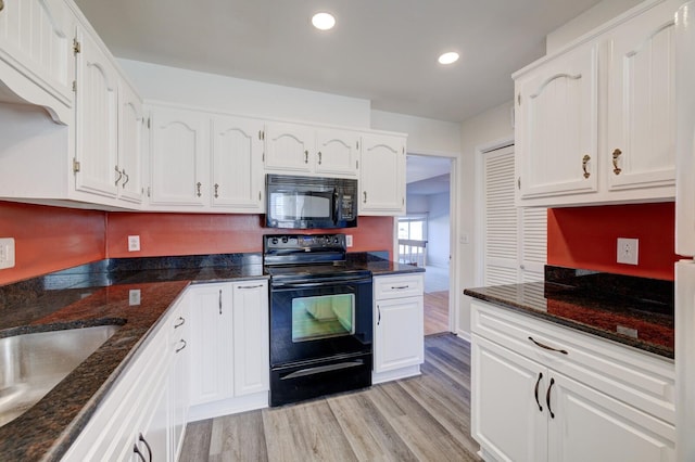 kitchen featuring black appliances, white cabinetry, sink, and light hardwood / wood-style flooring