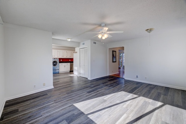 unfurnished living room featuring dark hardwood / wood-style floors, ceiling fan, a textured ceiling, and washer / clothes dryer