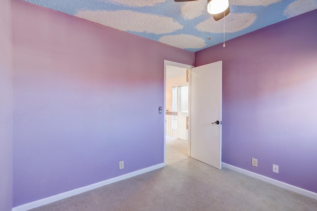 empty room featuring light carpet and ceiling fan