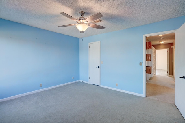 unfurnished bedroom with ceiling fan, a textured ceiling, and light carpet