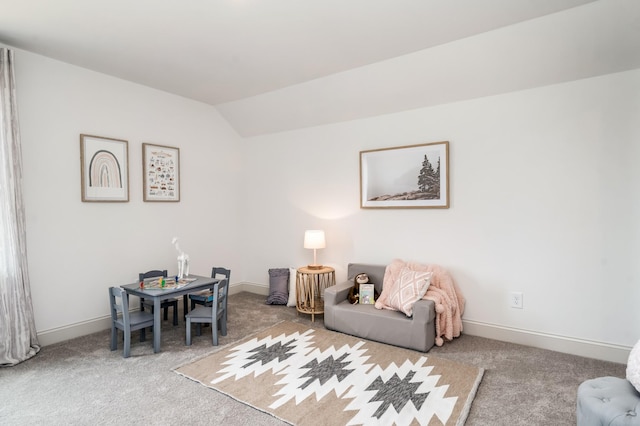 interior space with carpet flooring and vaulted ceiling