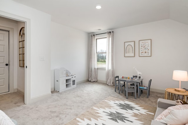 interior space featuring light carpet and lofted ceiling