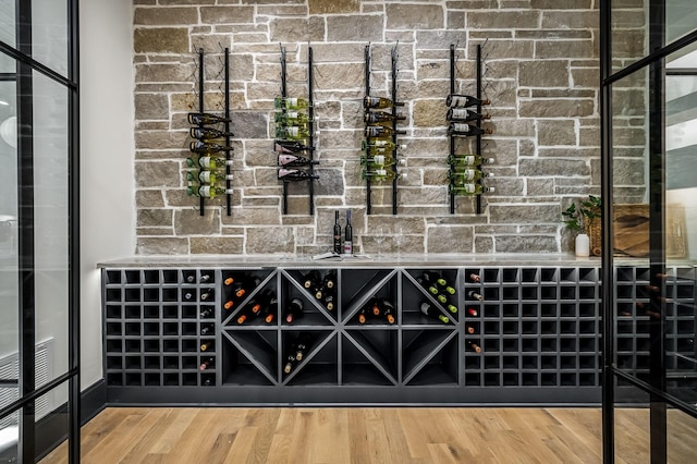 wine room with hardwood / wood-style flooring