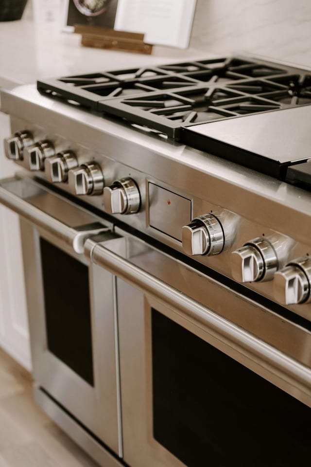 details featuring white cabinetry and double oven range