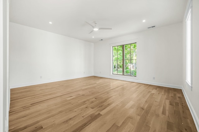 empty room with light hardwood / wood-style floors and ceiling fan