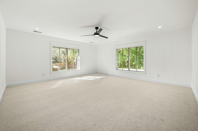 empty room featuring light colored carpet and ceiling fan