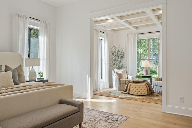 bedroom featuring beamed ceiling, wood-type flooring, and coffered ceiling