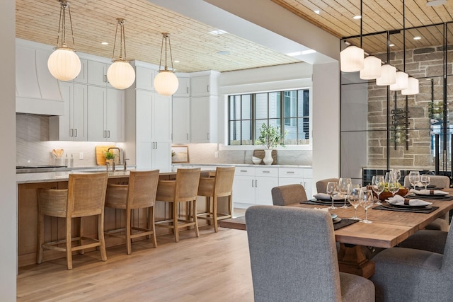 dining room with light wood-type flooring and sink