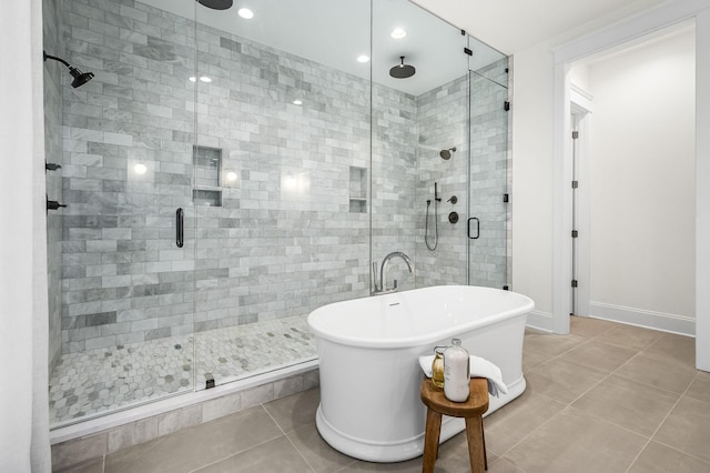 bathroom with tile patterned floors and independent shower and bath