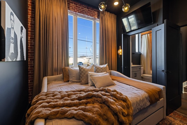 bedroom with brick wall and multiple windows