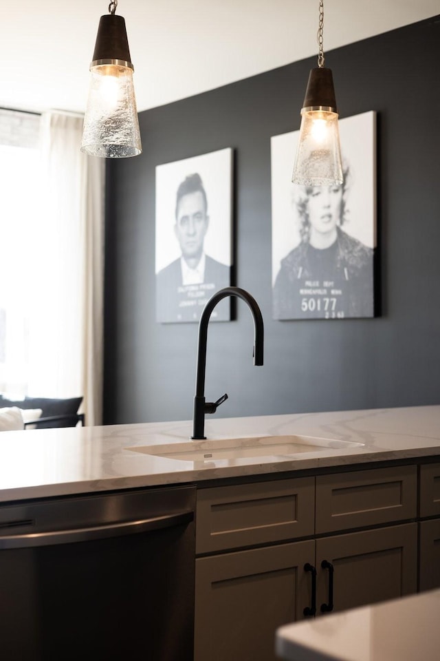 interior details with dishwashing machine, sink, gray cabinets, and pendant lighting