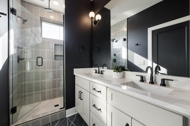 bathroom with a shower with shower door and vanity