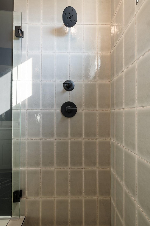 bathroom with tiled shower