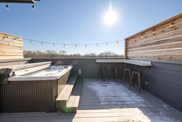 wooden terrace with a hot tub