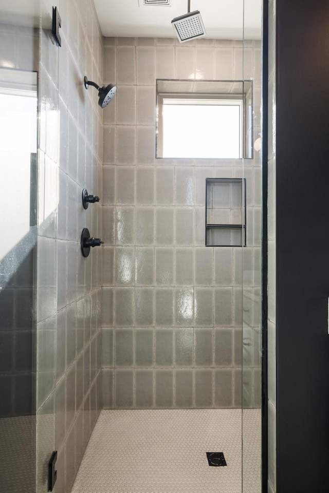 bathroom with a tile shower