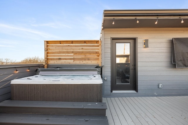 wooden deck with a hot tub