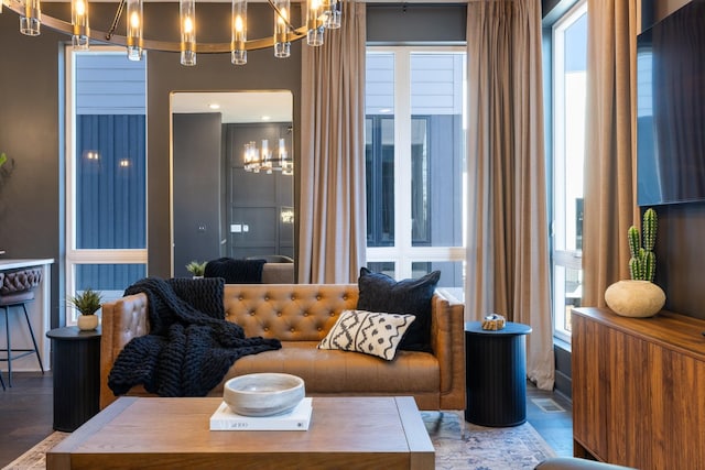 living room featuring an inviting chandelier and a healthy amount of sunlight