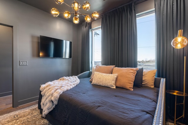 bedroom featuring a chandelier and hardwood / wood-style floors