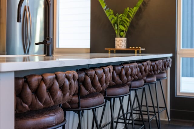 bar with stainless steel fridge and a healthy amount of sunlight