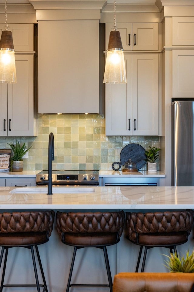 kitchen with decorative backsplash, a kitchen bar, and decorative light fixtures