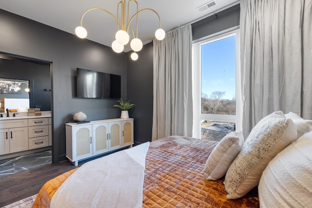 bedroom featuring sink and a notable chandelier