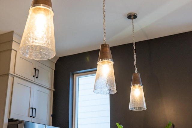 room details with pendant lighting and white cabinets