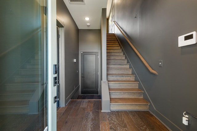 staircase featuring wood-type flooring