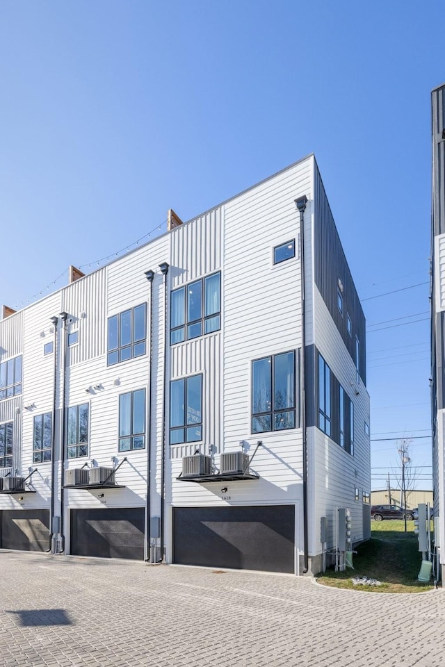 rear view of property with central AC unit