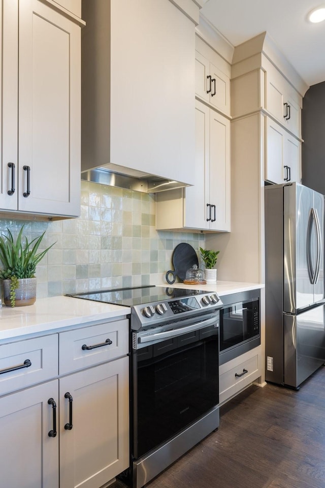 kitchen with decorative backsplash, dark wood-type flooring, stainless steel appliances, and wall chimney exhaust hood