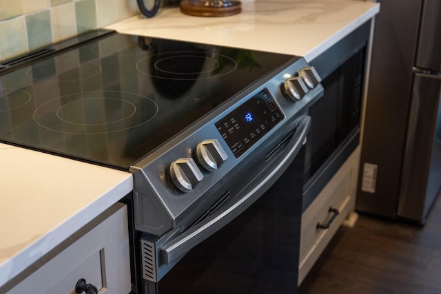 interior details featuring stainless steel appliances and backsplash