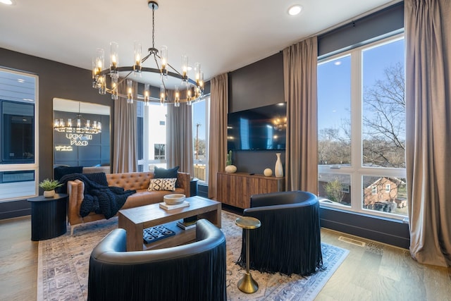 living room featuring a chandelier and wood-type flooring