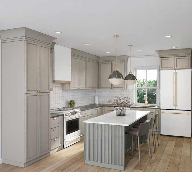 kitchen featuring pendant lighting, gray cabinetry, white refrigerator, sink, and stainless steel range