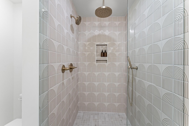 bathroom with tiled shower