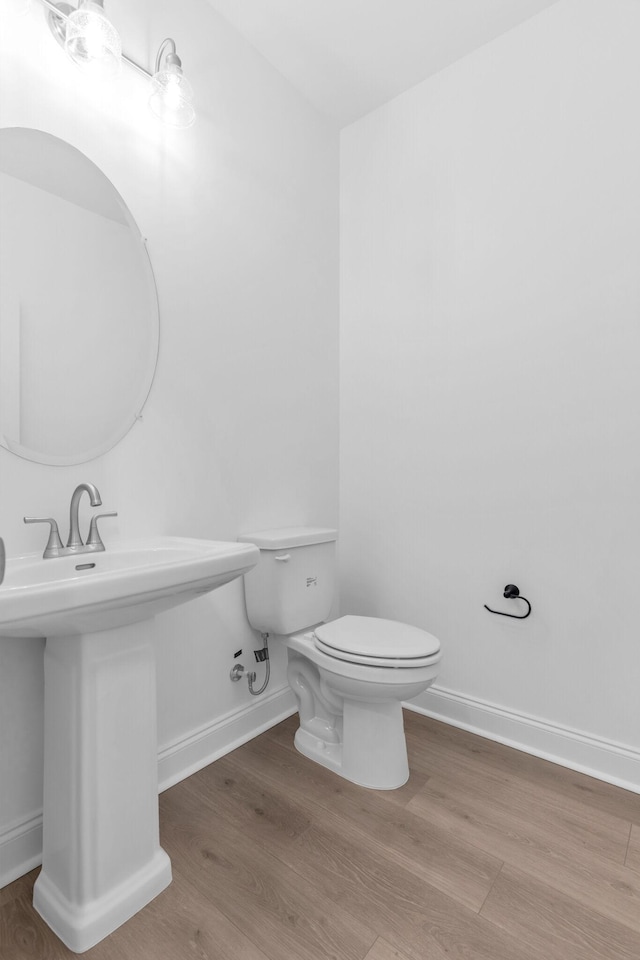 bathroom featuring hardwood / wood-style floors, toilet, and sink