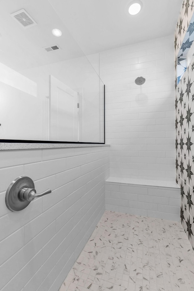 bathroom with a tile shower