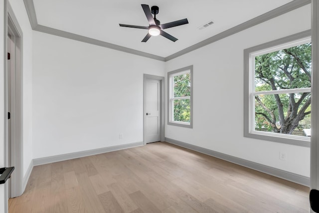 empty room with light wood-type flooring, ceiling fan, and ornamental molding