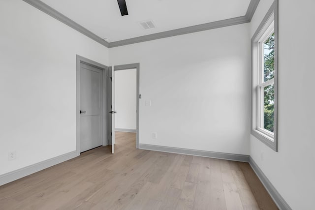 unfurnished room with light hardwood / wood-style flooring, a healthy amount of sunlight, and crown molding